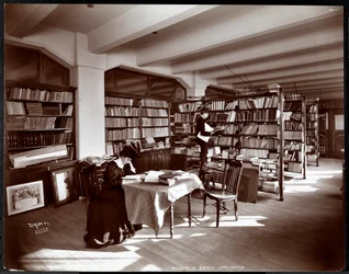 Woman and a young man in a library of the Museum of Safety Appliances of the American Institute of Social Service, New York